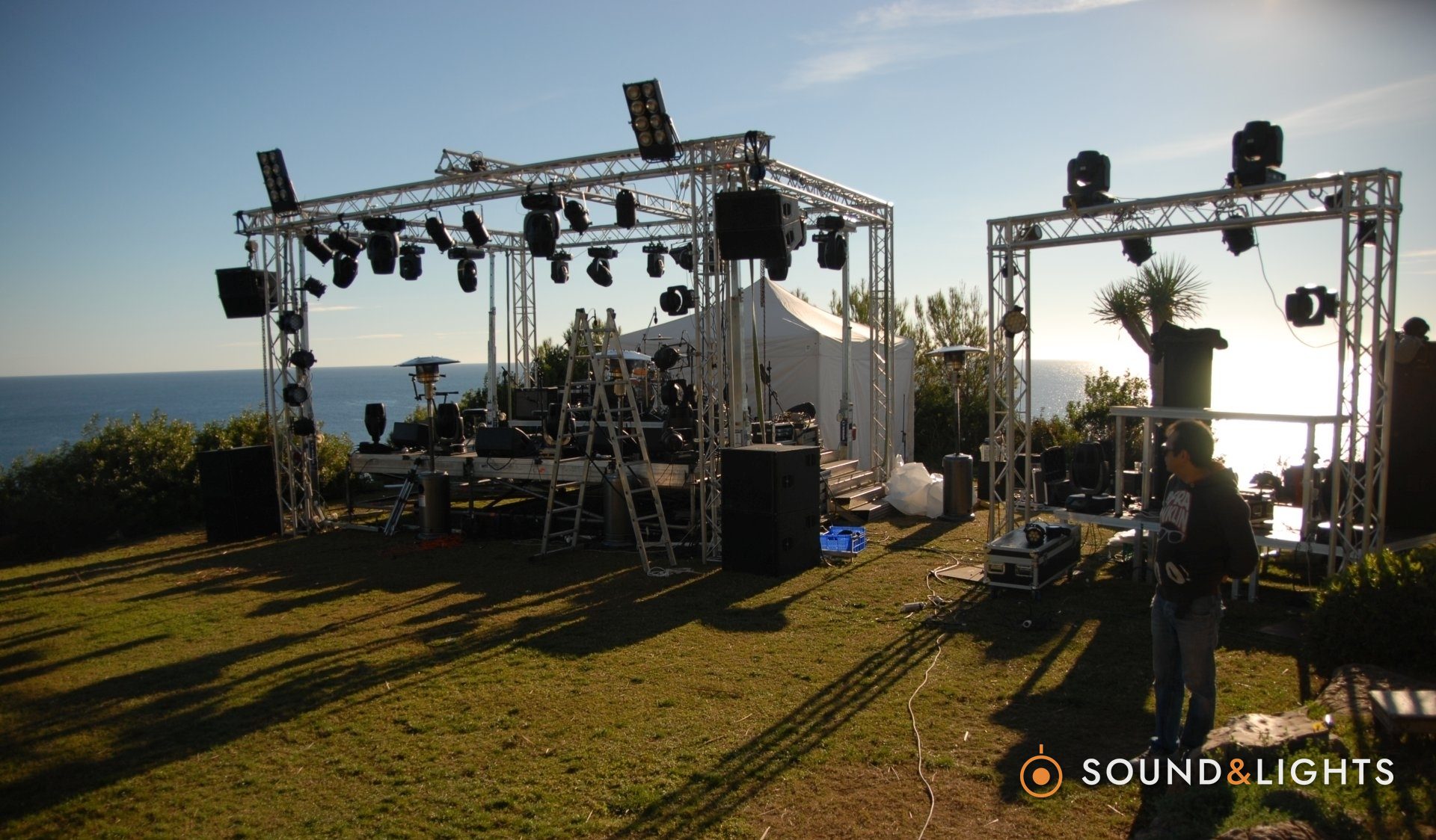 Private concert setup — Bluebay domain - Ibiza - DJ-booth, monintors, stage & truss rigs, lights and PA hire